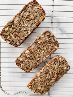 three slices of granola bread on a cooling rack