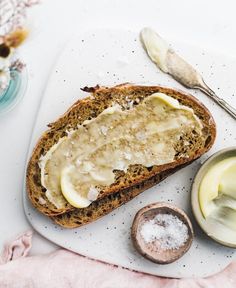 there is a piece of bread with butter on it next to some other food items