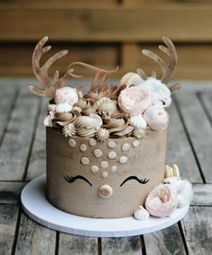 a cake decorated with flowers and antlers on a plate