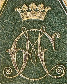 an ornate monogram with a crown on it