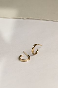 A lightweight everyday hoop. An idea born from the contour of inverted channel wire, the Plié reflects light to multiply its weight in visual interest. These simple hoops are lovely on their own, yet look excellent stacked for those with multiple lobe piercings. Minimalist Yellow Gold Cartilage Earrings For Everyday, Minimalist Yellow Gold Cartilage Earrings For Anniversary, Minimalist Recycled Gold Huggie Earrings, Everyday Recycled Gold Huggie Earrings, Minimalist 14k Yellow Gold Cartilage Earrings, Modern Twist Jewelry With Simple Design For Everyday, Modern Jewelry With Simple Design, Everyday Jewelry With A Modern Twist And Simple Design, Everyday Jewelry With A Modern Twist