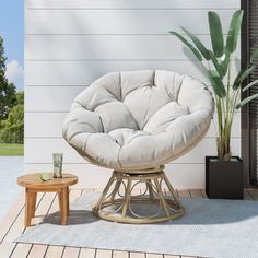 a chair sitting on top of a wooden floor next to a potted plant