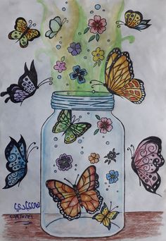 a jar filled with lots of butterflies on top of a table