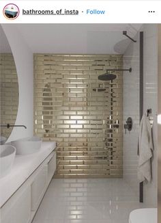 a bathroom with white and gold tiles on the wall, shower stall and sink area