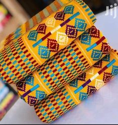 Kente fabric, Handwoven from Ghana. Kente yard is not the same as African fabric/ankara . This woven top-notch quality kente is not measured like the normal African fabric/Ankara. The Kente strips are joined together to make 2 yards for a piece in three to make 6 yards. The weavers weave it up to 14 or 15 stripes and join all the stripes to make the full 12 yards kente but when they weave it in small stripes it's either 17 or 18 stripes to make the full 12 yards kente. This is purely handwoven k Kente Fabric, Costume Africain, Africa Dress, African Wear Dresses, Kente Cloth, African Men, African Wear, Woven Top, African Fabric