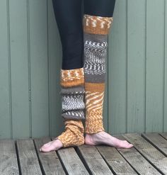 These hand knit over the knee, thigh high leg warmers will soon be your favorite.  Wear them over tights, with your shorts or under track pants.  They are long enough to pull over the knee, or slouched down over cold feet.  Perfect accessory for the cold fall and winter months.    Wear them to your yoga, Pilates or ballet class.   Hand knit from a warm and cozy yarn of 80% acrylic and 20% wool in solid and fair isle stripes of  gold, brown and white.   Color placement varies n each pair.  The pair you receive may be slightly different than pictured.  Measures approximately  26" in length, 12" at the knee and 8" at ankle.  Measurements taken flat before stretching.  Model is 5' 9" and wears a size 2/4.  Best fits a small/medium.   Machine wash warm, tumble dry low or hand wash and dry flat.