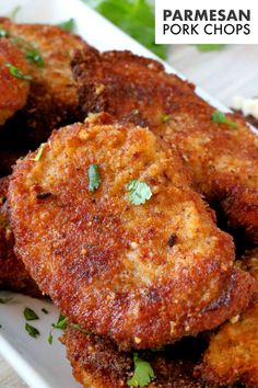 some fried food on a white plate and garnished with cilantro leaves