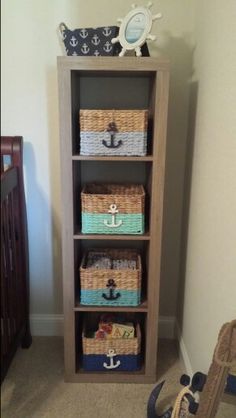 a wooden shelf with baskets and other items on it next to a baby's crib