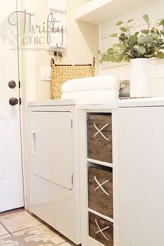 a white washer and dryer sitting next to each other in a laundry room