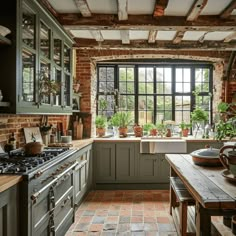 a kitchen with an oven, sink and table in it's center island surrounded by potted plants