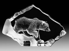 a glass bear figurine is shown on a black and white background with an iceberg in the foreground