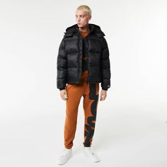 Comfortable, responsible, functional. Rain or shine, stay warm in this bold Lacoste jacket. Sporty Puffer Jacket For Streetwear In Fall, Sporty Puffer Jacket For Fall Streetwear, Sporty Puffer Outerwear For Streetwear, Sporty Streetwear Puffer Outerwear, Sporty Hooded Puffer Jacket For Fall, Winter Sportswear Puffer Jacket For Outdoor, Winter Athleisure Outerwear With Double-lined Hood, Fall Functional Puffer Jacket, Nylon Sportswear Outerwear For Cold Weather