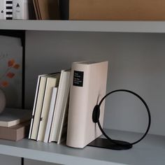 a bookshelf filled with lots of books next to a lamp