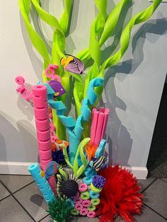 a vase filled with lots of different types of decorations on top of a tile floor