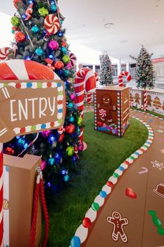 a christmas tree decorated with candy canes and candies in an office lobby area