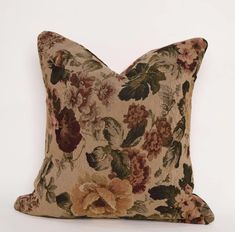 a floral pillow on a white background