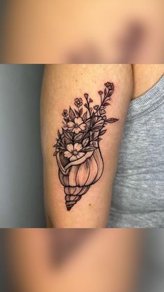 a woman's arm with a flower vase tattoo on the left side of her right arm