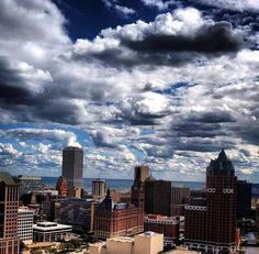 the city is surrounded by tall buildings and cloudy skies