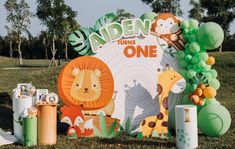 an outdoor birthday party with jungle animals and balloons