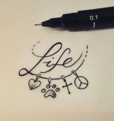 a pen is laying on top of a piece of paper with the word life written in cursive writing