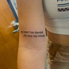 a woman with a tattoo on her arm that says, my heart has changed my soul has changed