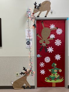 the door is decorated with christmas decorations and reindeers