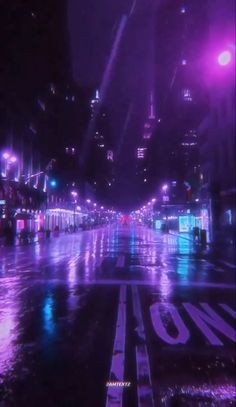 an empty city street at night in the rain