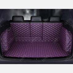 the trunk area of a car with purple carpet and black leather trims on it