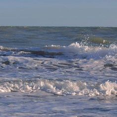 a man riding a surfboard on top of a wave in the ocean