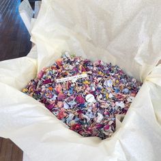 a box filled with lots of different types of confetti in it's wrapper