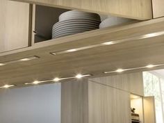 the lights are on in this kitchen under the cabinetry and above the countertop