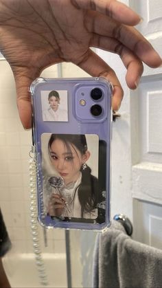 a person holding up a cell phone case with an image of a woman on it