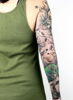 a woman wearing a green tank top with tattoos on her arm