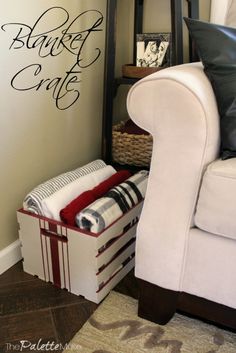 a white chair sitting next to a wall with a basket on it's back