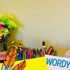 there is a yellow sign that says wordy on it and some crayons next to it