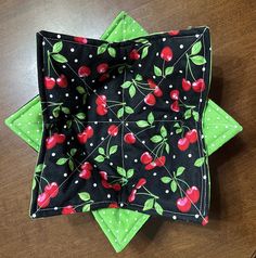 two black and green cloths with cherries on them