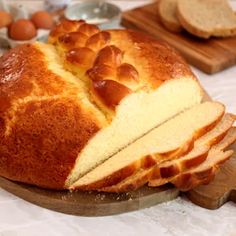 a loaf of bread with slices cut out on a cutting board