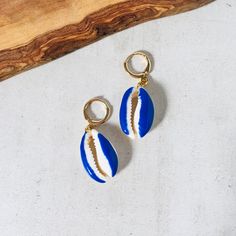 Colorful Shell Earrings Blue These Bright Earrings Are Cast Strung With Dainty Cowry Shells Coated In Glossy Blue Lacquer. Don't Just Reserve Yours For Tropical Vacations - They'll Add Such A Bohemian Feel To Cocktail Dresses And Jeans Too. 1.5” Check Out The Other Colors I Have In These And The Other Shell Pieces In My Collection. Boho Blue Hoop Earrings With Ear Wire For Beach, Blue Dangle Earrings For The Beach, Blue Ear Wire Earrings For The Beach, Blue Jewelry For Summer Vacation, Summer Vacation Blue Jewelry, Blue Hoop Earrings As Summer Gift, Blue Hoop Earrings For Summer Gift, Blue Hoop Earrings As A Summer Gift, Blue Earrings For Vacation