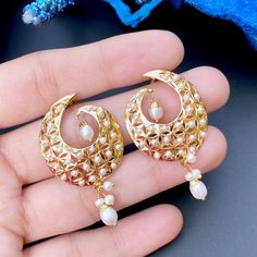 These stunning 8.94 GM pearl earrings, designed in 22ct gold and featuring 0.70 GMs of hanging beads, provide a timeless beauty. Delicately crafted and perfect for any important event, they will add a sophisticated touch to your style. Watch Video Here Elegant Pearl Meenakari Earrings For Diwali, Elegant White Kundan Earrings, Wedding Meenakari Pearl Earrings, Elegant Gold-plated Meenakari Pearl Earrings, Elegant Meenakari Gold-plated Pearl Earrings, Elegant Pearl Chandbalis With Pearl Drop, White Chandbali Pearl Earrings For Formal Occasions, Elegant Pearl Drop Chandbalis For Festivals, Elegant Gold Pearl Earrings With Meenakari