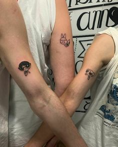 two people with matching tattoos on their arms