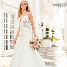 a woman in a wedding dress holding a bouquet