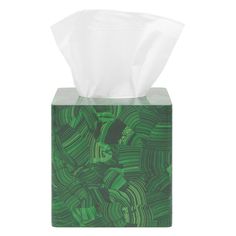 a tissue dispenser with green swirls on it