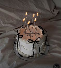 a birthday cake with lit candles on it