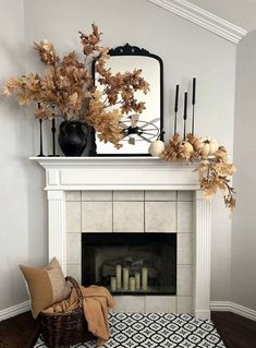 a living room with a fireplace, mirror and decorative items on top of the mantle