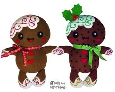 two christmas gingerbread dolls are standing next to each other