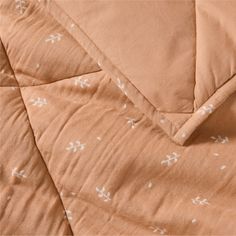 an orange blanket with white arrows on it