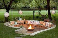 a fire pit in the middle of a grassy area