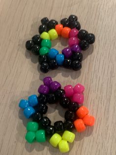 several different colored candy candies arranged on a table top with one being smaller than the other