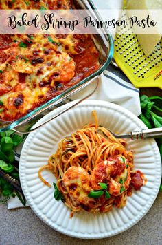 baked shrimp parmesan with pasta on a plate next to a casserole dish