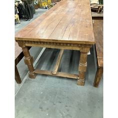 an old wooden table is being displayed in a store